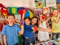 Small students girl finger painting in art school class. Royalty Free Stock Photo