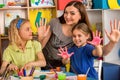 Small students girl finger painting in art school class. Royalty Free Stock Photo