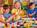 Small students girl finger painting in art school class. Royalty Free Stock Photo