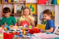 Small students girl finger painting in art school class. Royalty Free Stock Photo