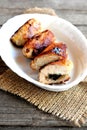 Small stuffed turkey meat rolls on a plate and on old wooden table. Fried turkey breast rolls with cheese and agaricus.