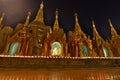 Small stupas illuminated with candles. Shwedagon Pagoda. Yangon. Myanmar Royalty Free Stock Photo