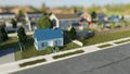 Small suburban house in a nice neighborhood. Tilt shift effect. Digital 3D render