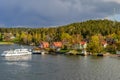 A small suburban passenger ferry Varmdo, public transport of the city of Stockholm, arrives to the ferry pier in Hasseludden, Royalty Free Stock Photo