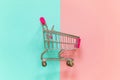 Toy cart on pastel pink and blue background Royalty Free Stock Photo