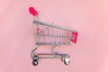 Toy cart on pastel pink background Royalty Free Stock Photo