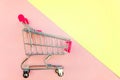 Toy cart on pastel pink and yellow background Royalty Free Stock Photo