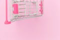Small supermarket grocery toy push cart isolated on pink pastel colorful background Royalty Free Stock Photo