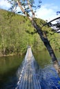 small suspension footbridge over a small river in norway