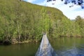small suspension footbridge over a small river in norway