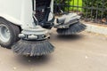 Small sweeper machine standing at parking storage after cleaning city park alley.Sweeping vacuum cleaner vehicle removing dust and Royalty Free Stock Photo