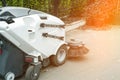 Small sweeper machine standing at parking storage after cleaning city park alley.Sweeping vacuum cleaner vehicle Royalty Free Stock Photo