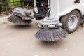 Small sweeper machine standing at parking storage after cleaning city park alley.Sweeping vacuum cleaner vehicle removing dust and Royalty Free Stock Photo