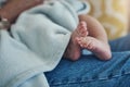So small, so sweet, adorable little baby feet. an unrecognizable woman relaxing with her baby on the sofa at home. Royalty Free Stock Photo