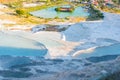 The small swimming pools full of water in the white rocks made of calcium carbonate and the small lake with Royalty Free Stock Photo