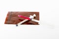 Small syringe lay on brown pill bag on white background,small syringe for pet hospital Royalty Free Stock Photo