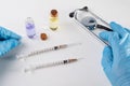 A small syringe, medicine and doctor& x27;s hands in gloves. Utensils necessary for treatment at the clinic Royalty Free Stock Photo