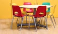 small table with colored chairs in the kindergarten classroom Royalty Free Stock Photo