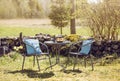 Small table set in rural home garden with chairs and table for two  freshly baked pastries on table  sunny spring morning. Royalty Free Stock Photo