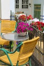 Small table and two chairs on a fenced terrace Royalty Free Stock Photo