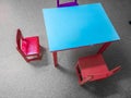 Small tables and chairs near blackboard on wall in kids club Royalty Free Stock Photo