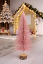 Small tabletop Christmas tree on background decorations. Vertical orientation