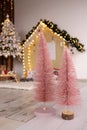 Small tabletop Christmas trees on background decorations. Vertical orientation