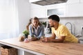 Small talks. Man and woman standing in the kitchen chitchatting while they drinking coffee after female come back home from her Royalty Free Stock Photo