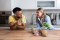 Small talks. Man and woman standing in the kitchen chitchatting while they drinking coffee after female come back home from her Royalty Free Stock Photo