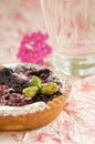 Small tartelette with prunes and pistachio nuts