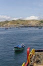 A small Taxi Boat with a Fisherman heading to an Offshore supply Vessel ready to take the Crew ashore to Chimera