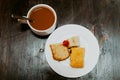 Small tea cakes and coffee on a wooden table, top down flatlay view Royalty Free Stock Photo