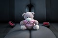 Small teddy bear not fastened sitting on a car seat