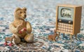 Small teddy bear watch cartoons in the television - scene with old toys Royalty Free Stock Photo