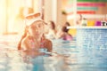 Small teenage girl in hotel resort pool near a bar Royalty Free Stock Photo