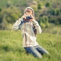 Small teenage girl taking photo with old camera