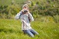 Small teenage girl taking photo with old camera