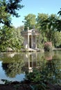 Lake and roman temple of escalapio in a park in Rome