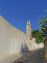 A small Terrace with Iron Railings overlooking a small Cobbled Street below the walls of the Palace of Estoi.