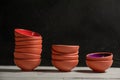 Small terracotta bowls on table. Black background