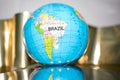small terrestrial globe south america and africa side isolated on shades of white and gold