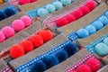 Small textile purses with colourful pompoms on display at street market in Morocco Royalty Free Stock Photo