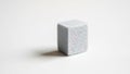 A small textured cube positioned against a plain white background Royalty Free Stock Photo