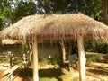 Small thatch cottage hut with hay stack in village Royalty Free Stock Photo