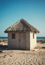 Small Thatched Beach Hut on Sandy Shore Royalty Free Stock Photo