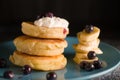 Small thick pancake with berries and sour cream on a beautiful blue plate home cooking tomorrow with goodies