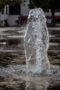 Small thick water jet of a park fountain, close up. Royalty Free Stock Photo