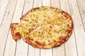 Small thin-crust pizza with lots of white onion, sliced green peppers and spicy salami with mozzarella cheese Royalty Free Stock Photo