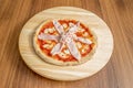 Small thin crust pizza with mozzarella cheese and lots of cooked ham Royalty Free Stock Photo