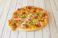 Small Thin Crust Pizza with Mushrooms, Ham, Sliced Green Peppers and Spicy Pepperoni with Mozzarella Cheese Royalty Free Stock Photo